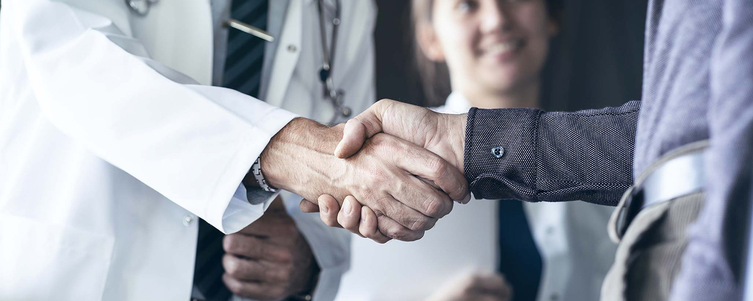 doctor shakes hands with patient