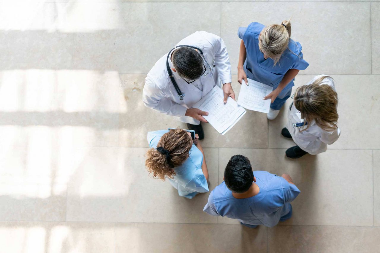 aerial view of doctors and nurses talking in a circle