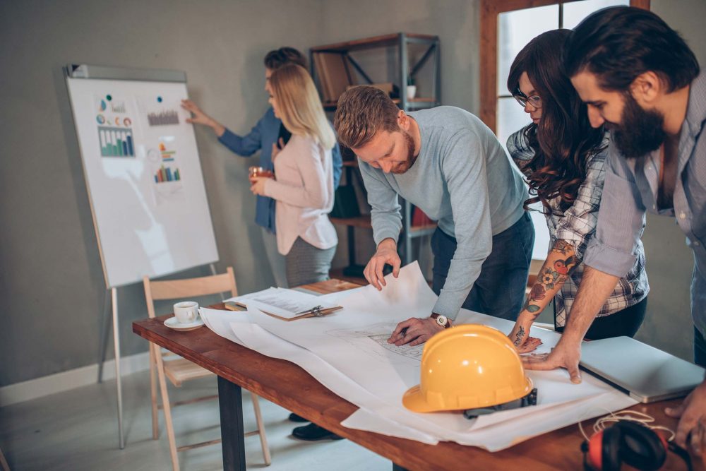 group of young engineers working together in modern office